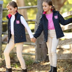 Two young girls wearing jodhpurs and coats